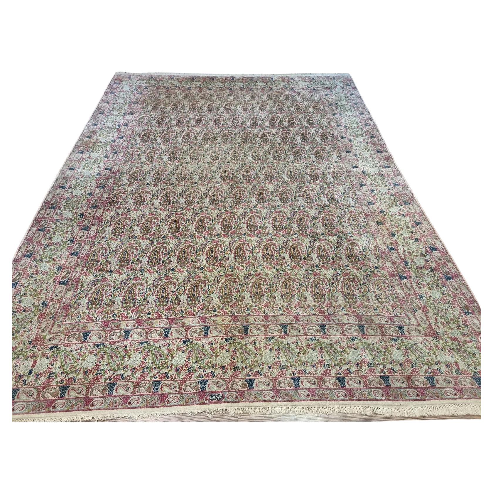 Full view of a handmade vintage Persian Kerman rug from the 1930s, featuring soft beige tones, classic intricate patterns, and a large room-size format measuring 9.8 x 13 feet.

