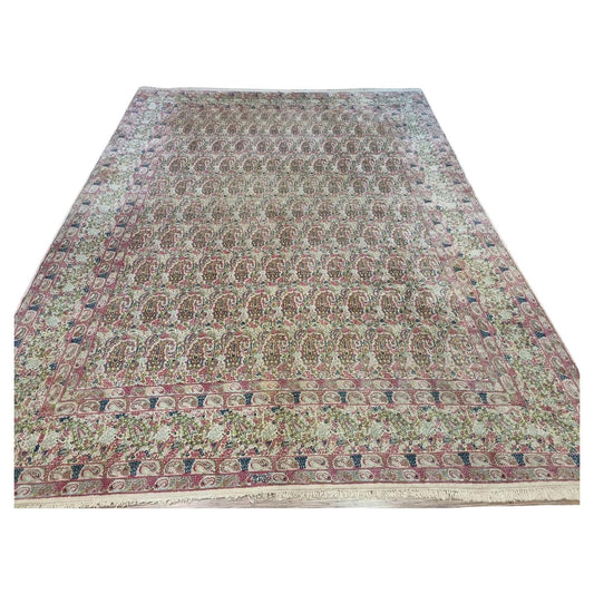 Full view of a handmade vintage Persian Kerman rug from the 1930s, featuring soft beige tones, classic intricate patterns, and a large room-size format measuring 9.8 x 13 feet.

