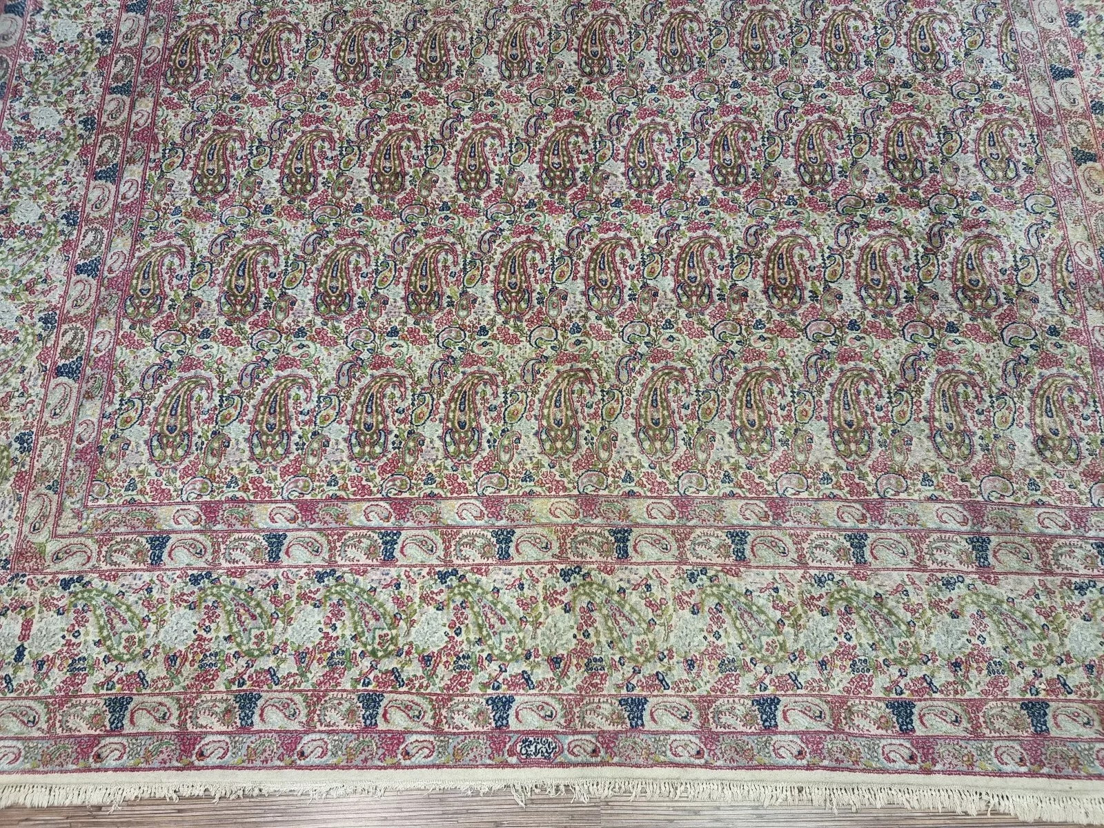 Vintage 1930s Kerman rug displayed in a room setting, demonstrating its generous dimensions (298 x 395 cm) and timeless Persian elegance.

