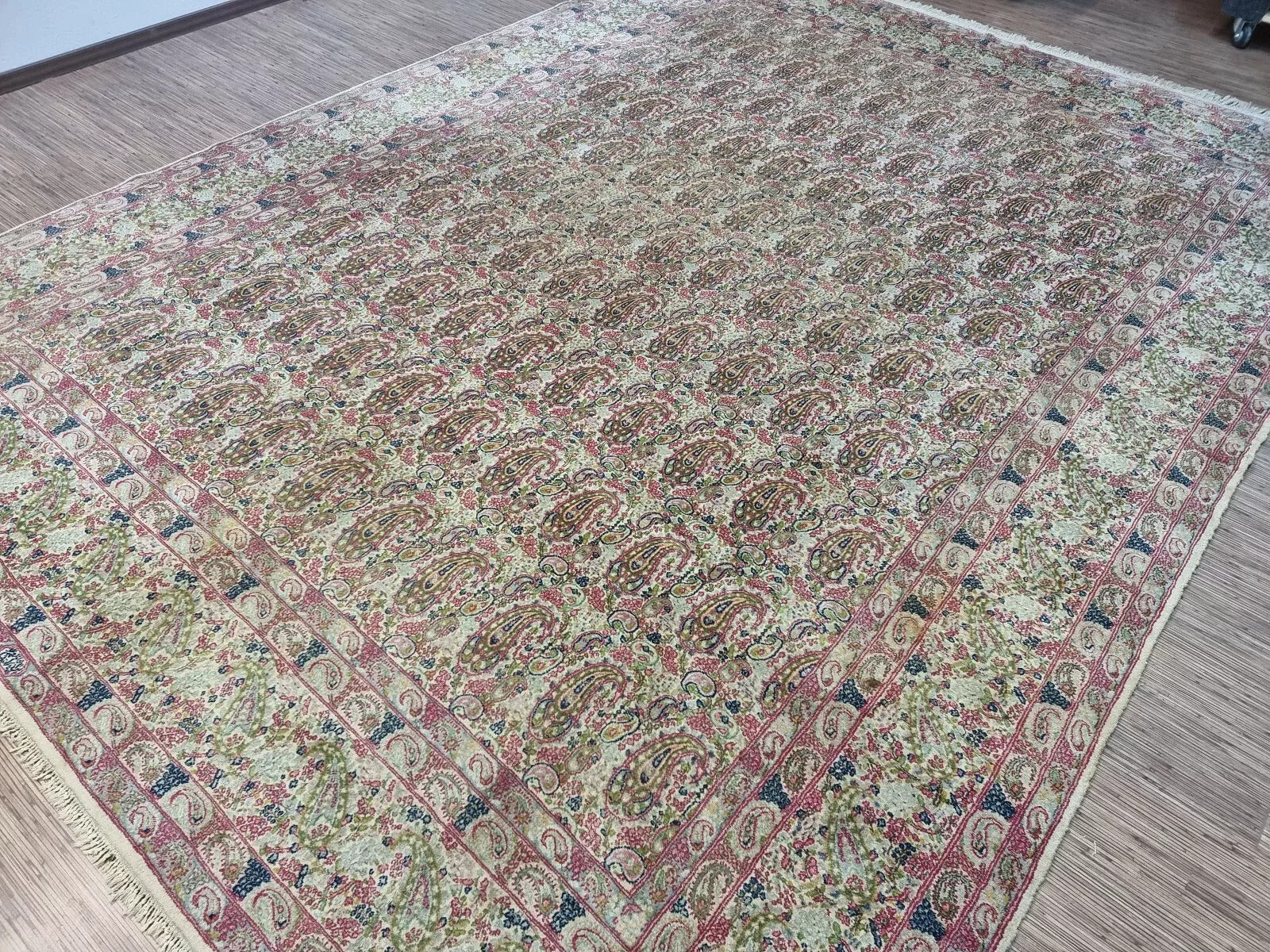 Close-up of the wool pile and hand-knotted weave on a 1930s Persian Kerman rug, highlighting the soft yet resilient texture on a cotton foundation.

