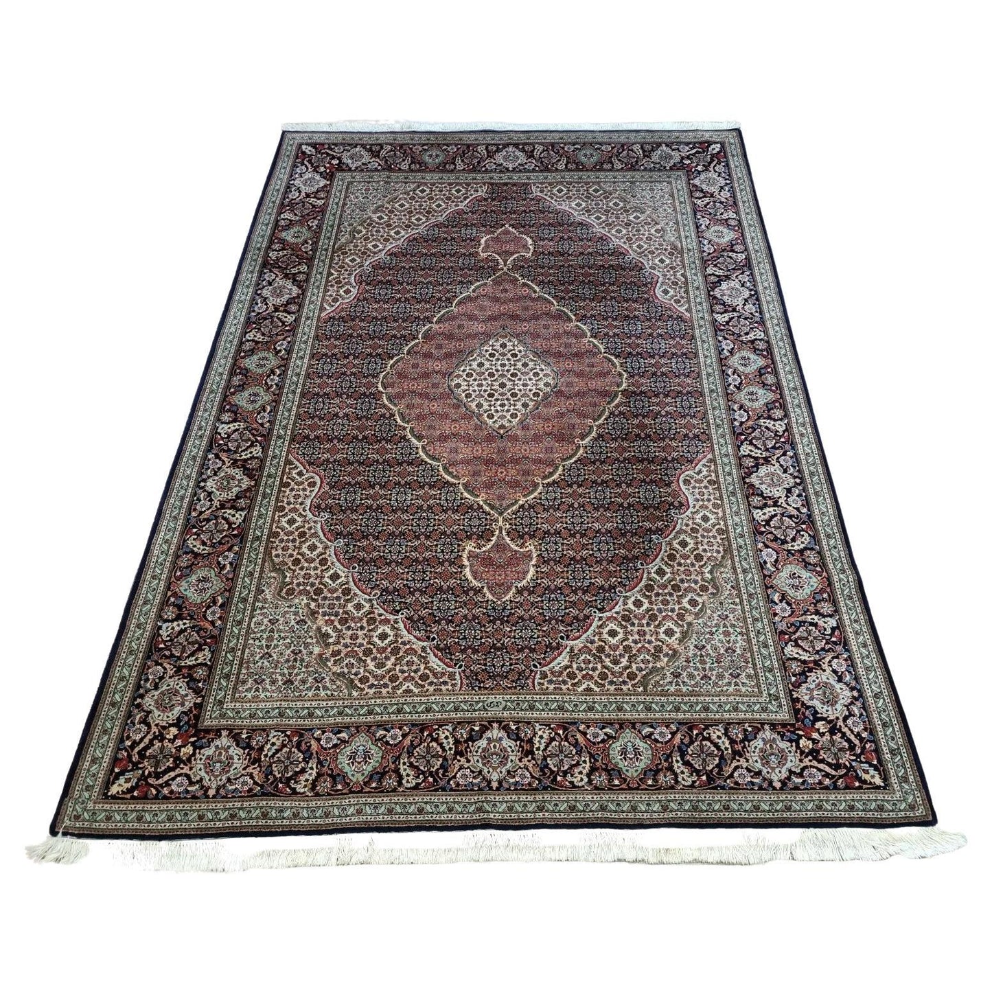 Full view of a handmade vintage Persian Tabriz rug from the 1970s, featuring a detailed floral pattern in rich blue tones, hand-knotted with approximately 500,000 knots per square meter.

