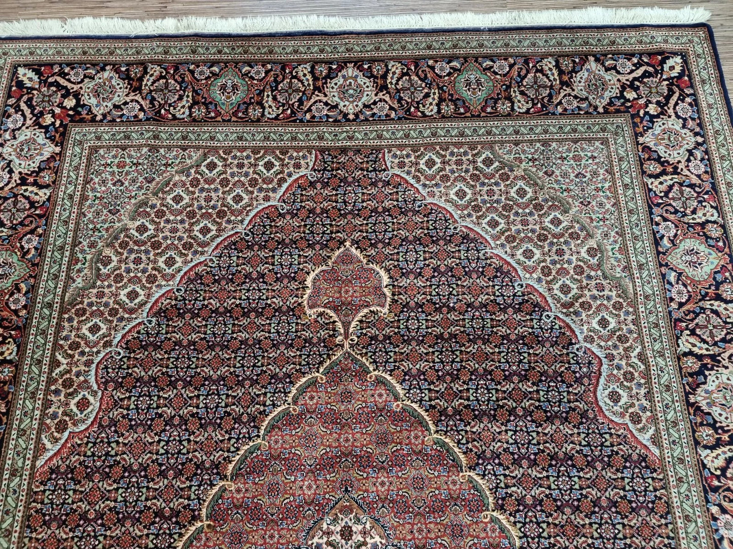 Full perspective of a vintage Persian Tabriz rug displayed in an interior setting, demonstrating its versatility for living rooms, dining areas, or elegant spaces.


