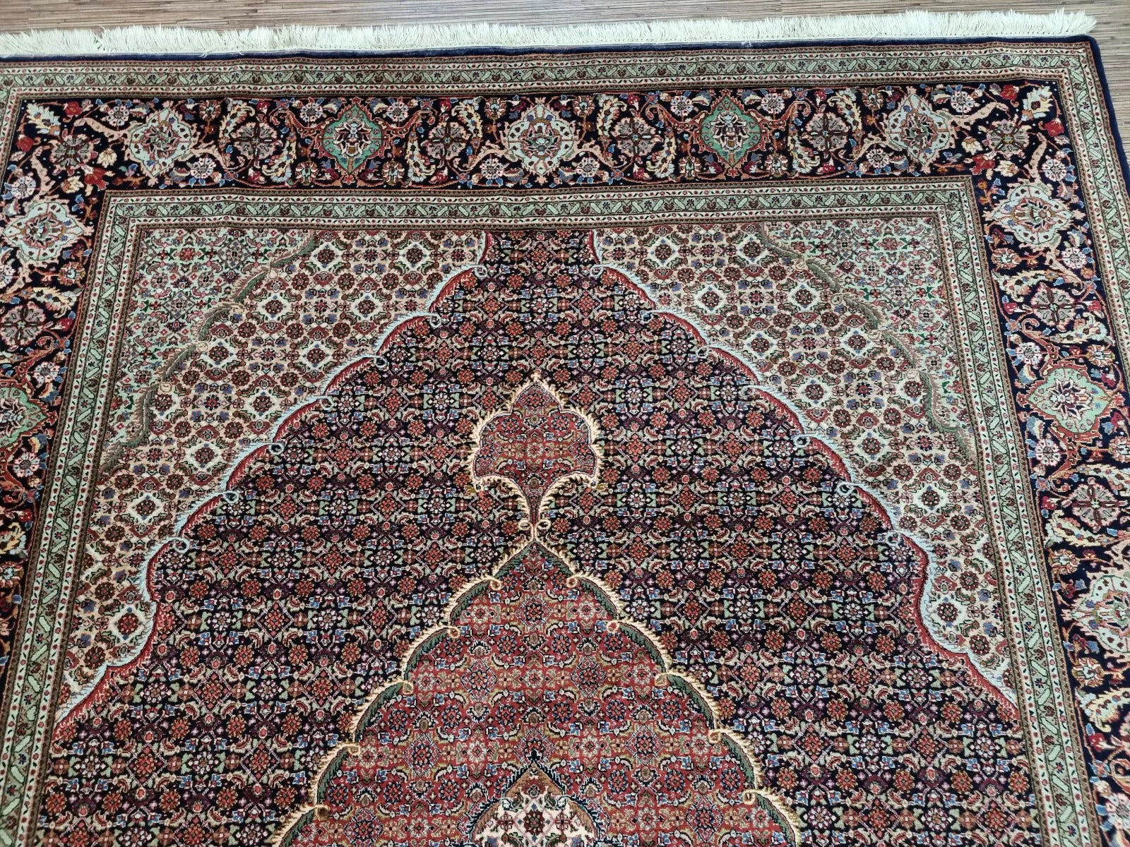 Full perspective of a vintage Persian Tabriz rug displayed in an interior setting, demonstrating its versatility for living rooms, dining areas, or elegant spaces.

