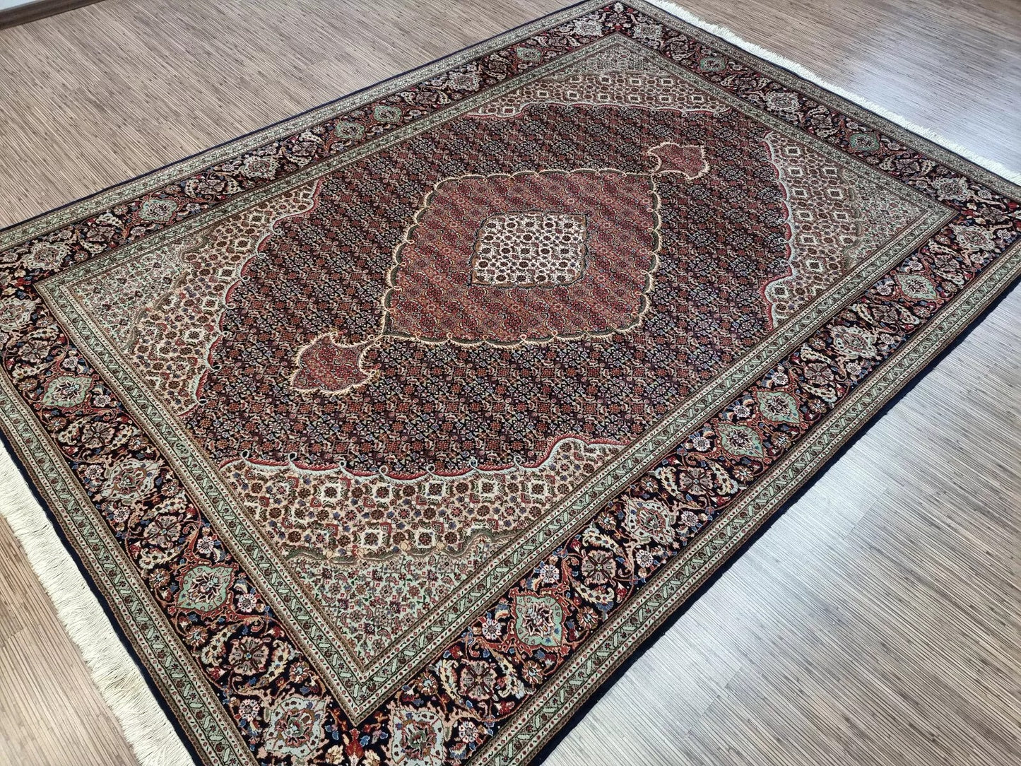 Close-up of the wool pile and hand-knotted weave on a 1970s Persian Tabriz rug, highlighting the soft yet resilient kork wool on a durable cotton foundation.

