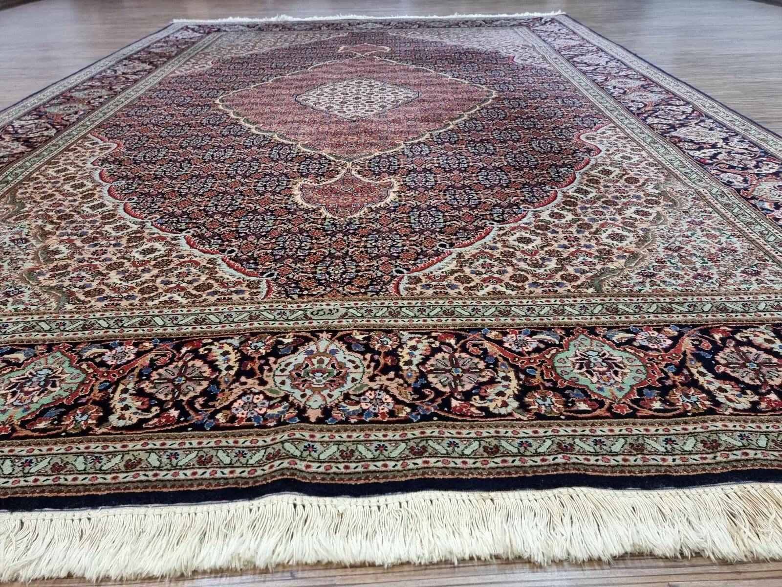 Collector-quality vintage Persian Tabriz carpet circa 1970s with intricate allover floral design, rich blue palette, and exceptional craftsmanship with 500,000 knots per square meter.

