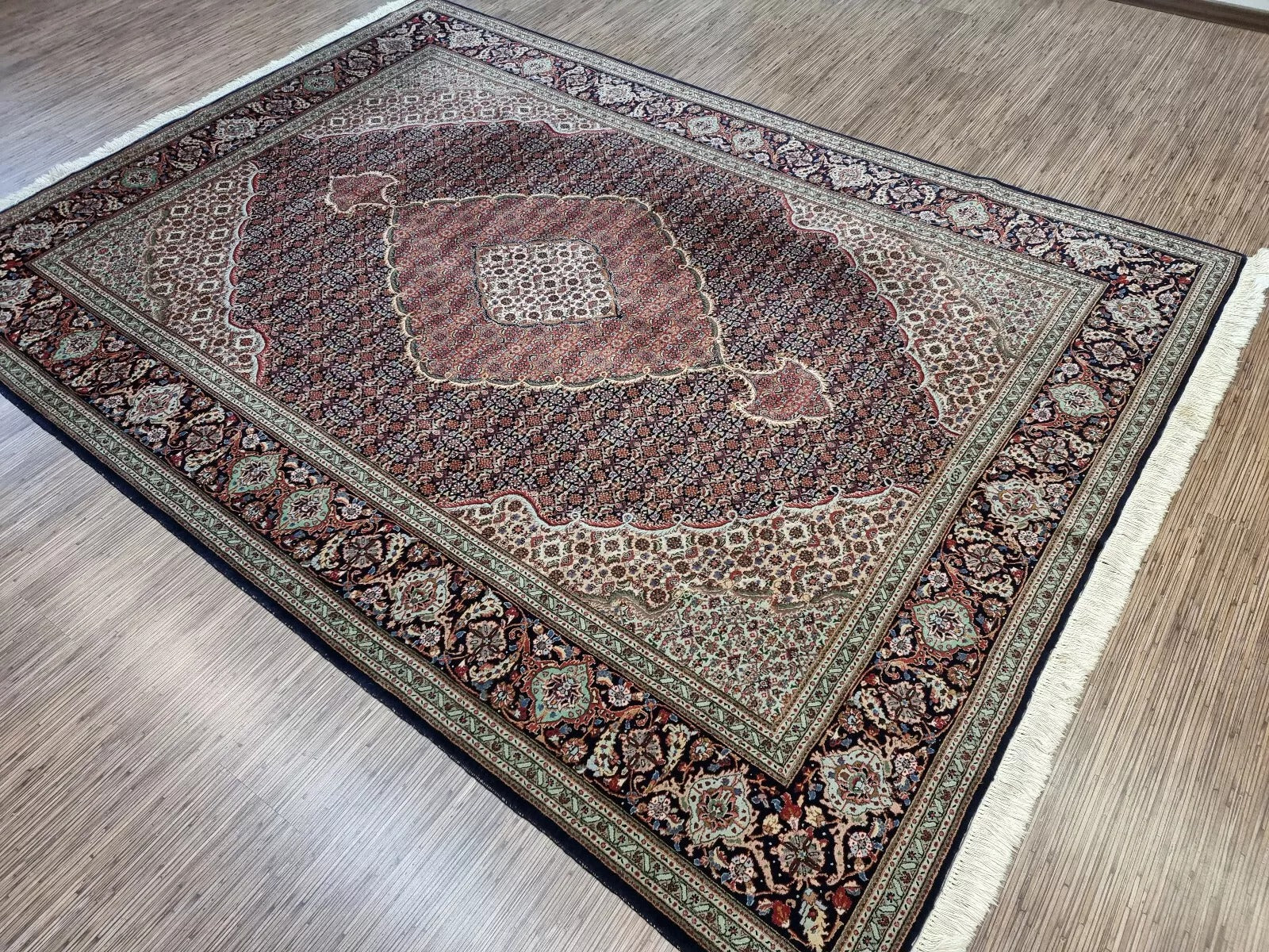 Large vintage Persian rug from Tabriz, hand-knotted in the 1970s, featuring detailed floral sprays, rosettes, and vine scrolls in traditional Persian elegance.

