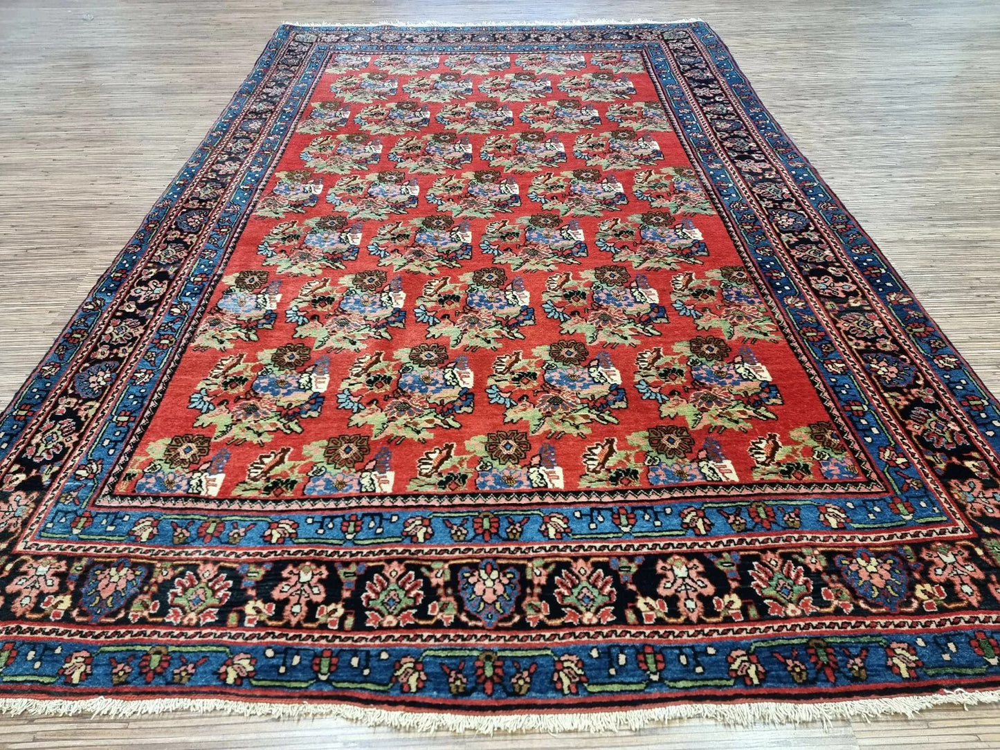 Collector-quality antique Persian Bidjar carpet circa 1900s with elegant allover floral design, warm rust-red tones, and exceptional well-preserved condition.

