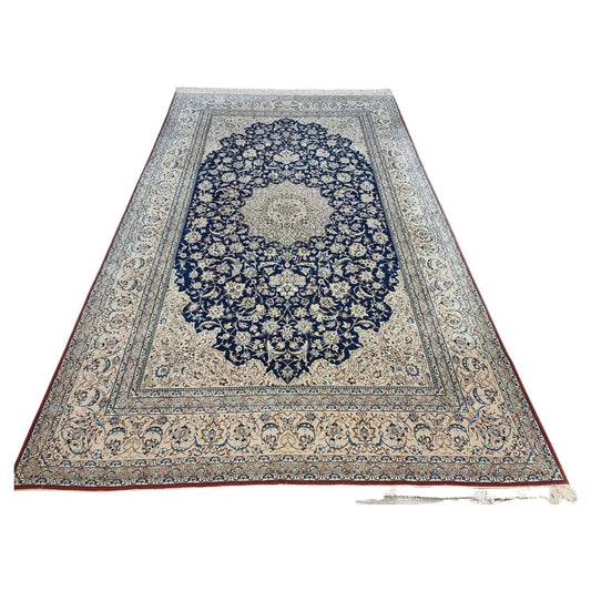 Full view of an antique Persian Nain 6La Tudeshk rug from the 1920s, featuring a traditional ivory field with intricate floral motifs and a central medallion, hand-knotted with approximately 800,000 knots per square meter in kork wool with silk highlights.

