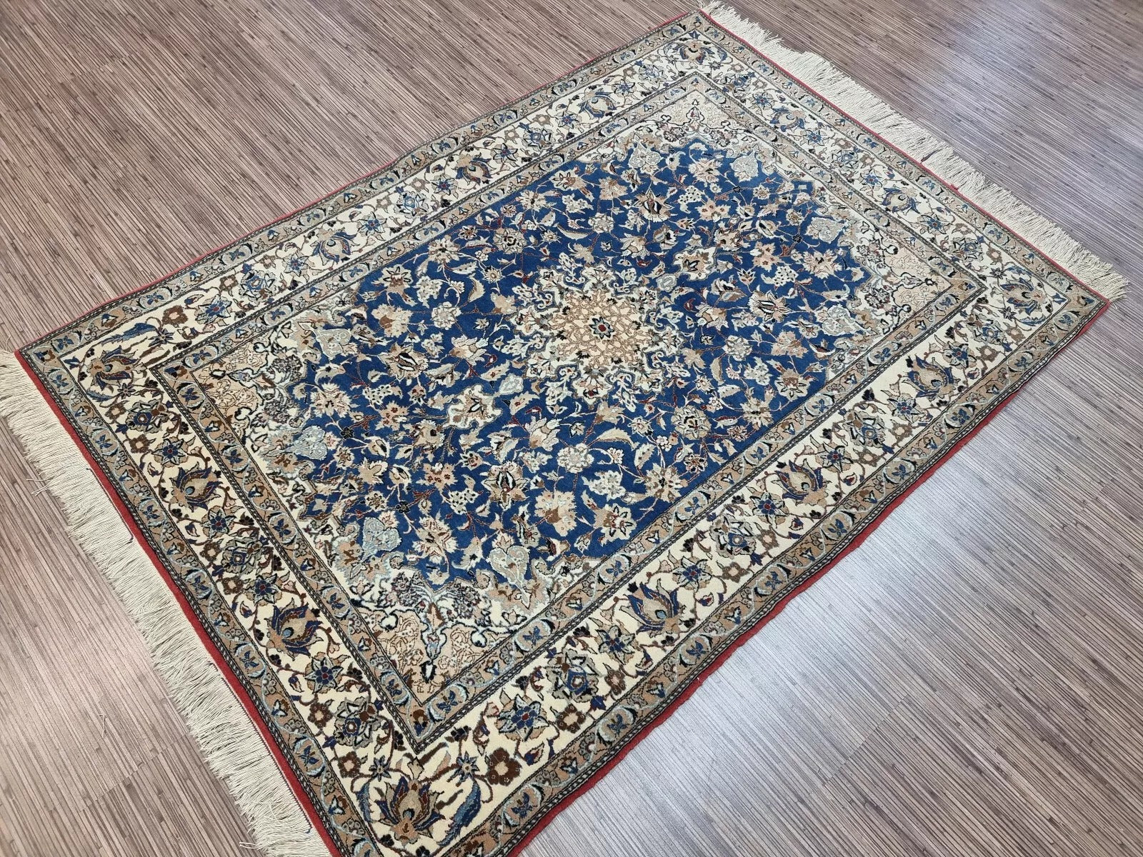 Close-up of the high-knot-density weave on a 1920s Persian Nain rug, showing the precision of approximately 800,000 knots per square meter in kork wool on cotton foundation.

