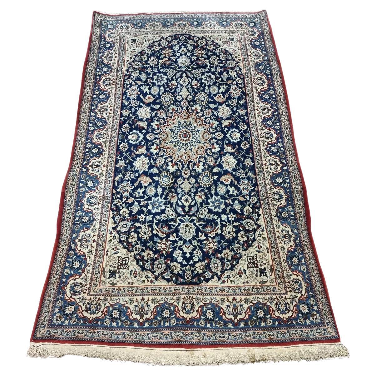 Full view of an antique Persian Nain 6La Tudeshk rug from the 1920s, featuring a soft ivory field with intricate floral medallions and arabesques, hand-knotted with approximately 800,000 knots per square meter in kork wool on a cotton foundation.

