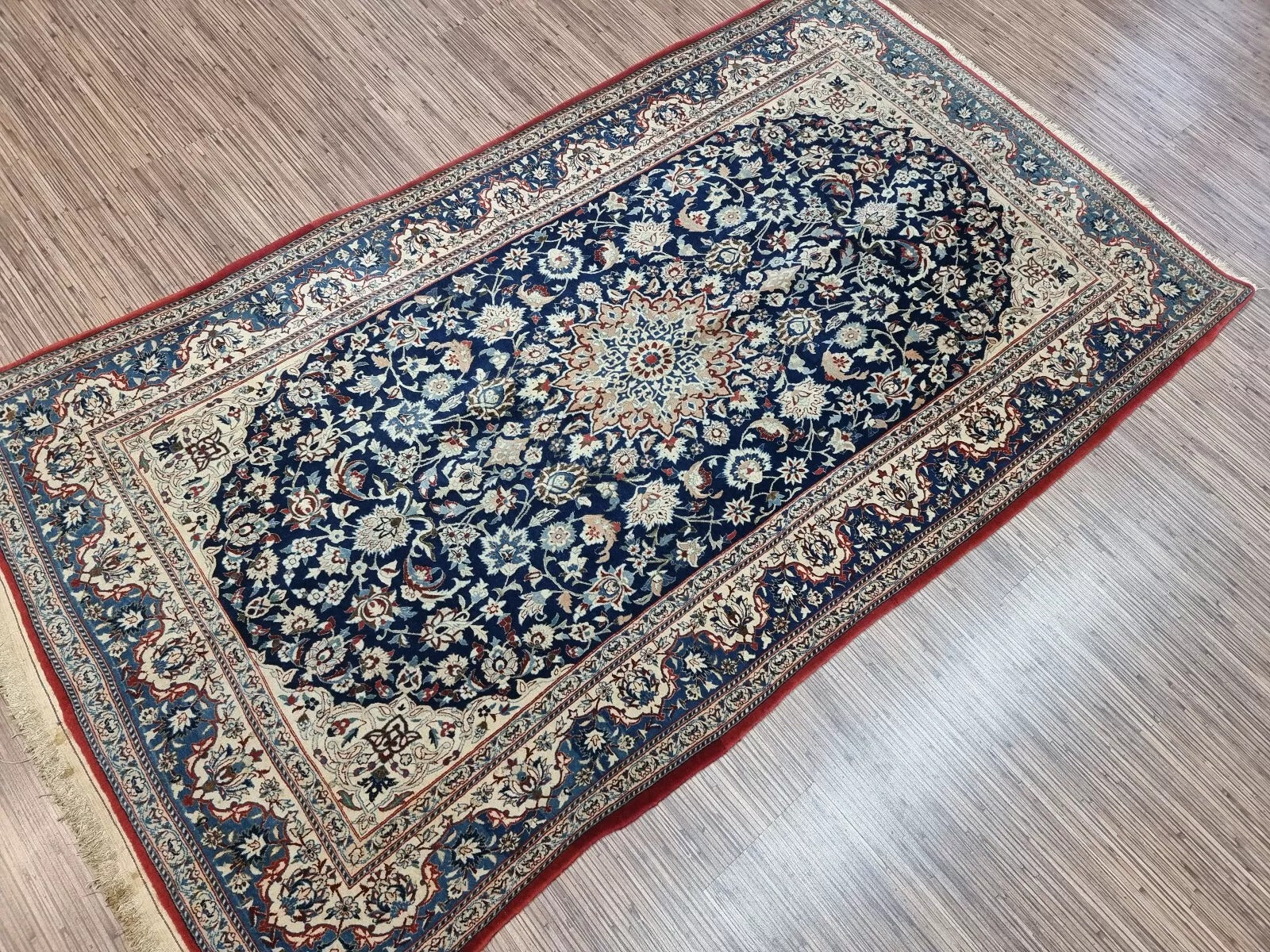 Close-up of the high-knot-density weave on a 1920s Persian Nain rug, showing the precision of approximately 800,000 knots per square meter in kork wool on cotton foundation.

