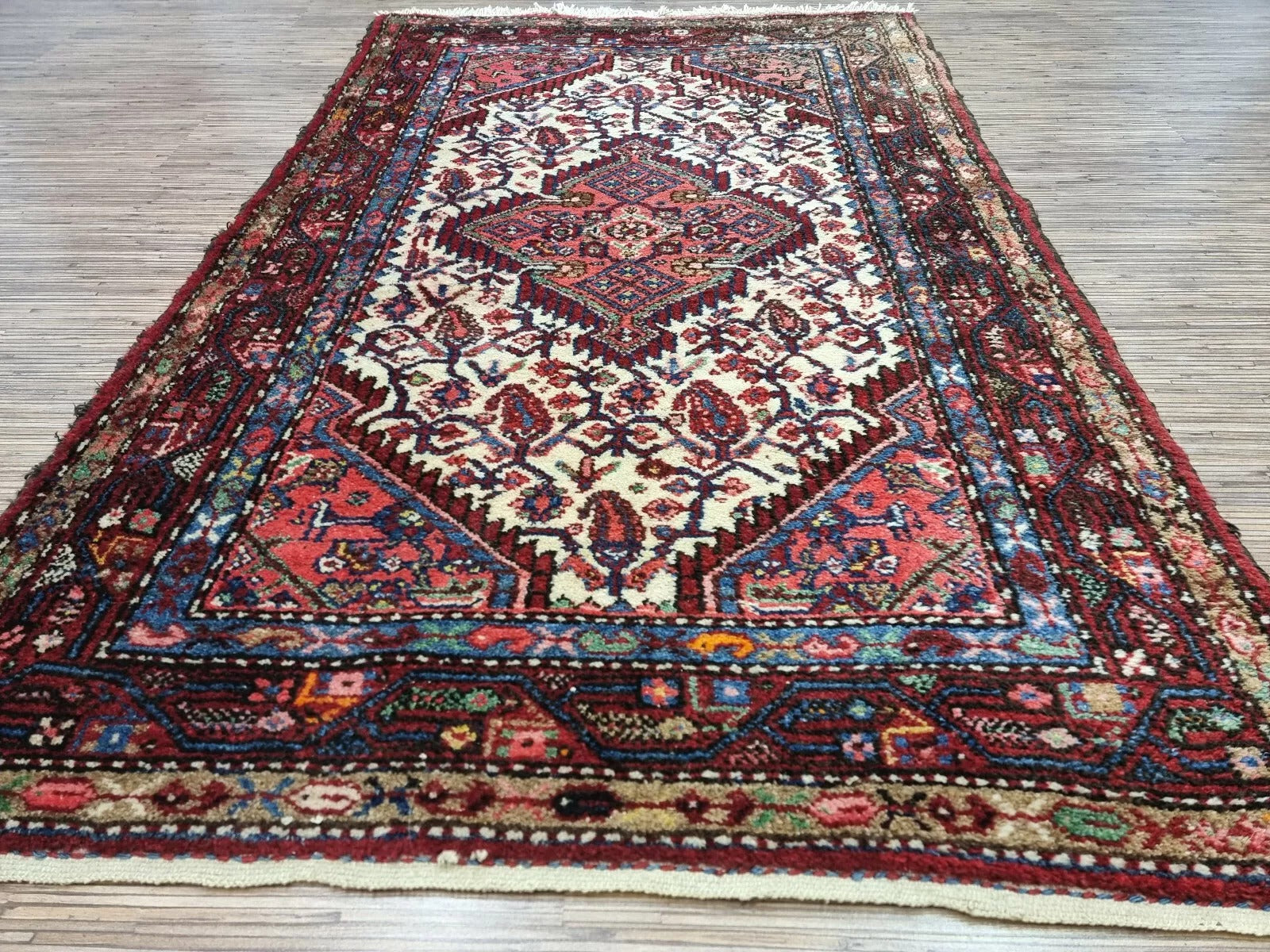Close-up of the weave on a 1950s Persian Hamadan rug, showing the hand-knotted wool pile on a durable cotton foundation with meticulous attention to detail.

