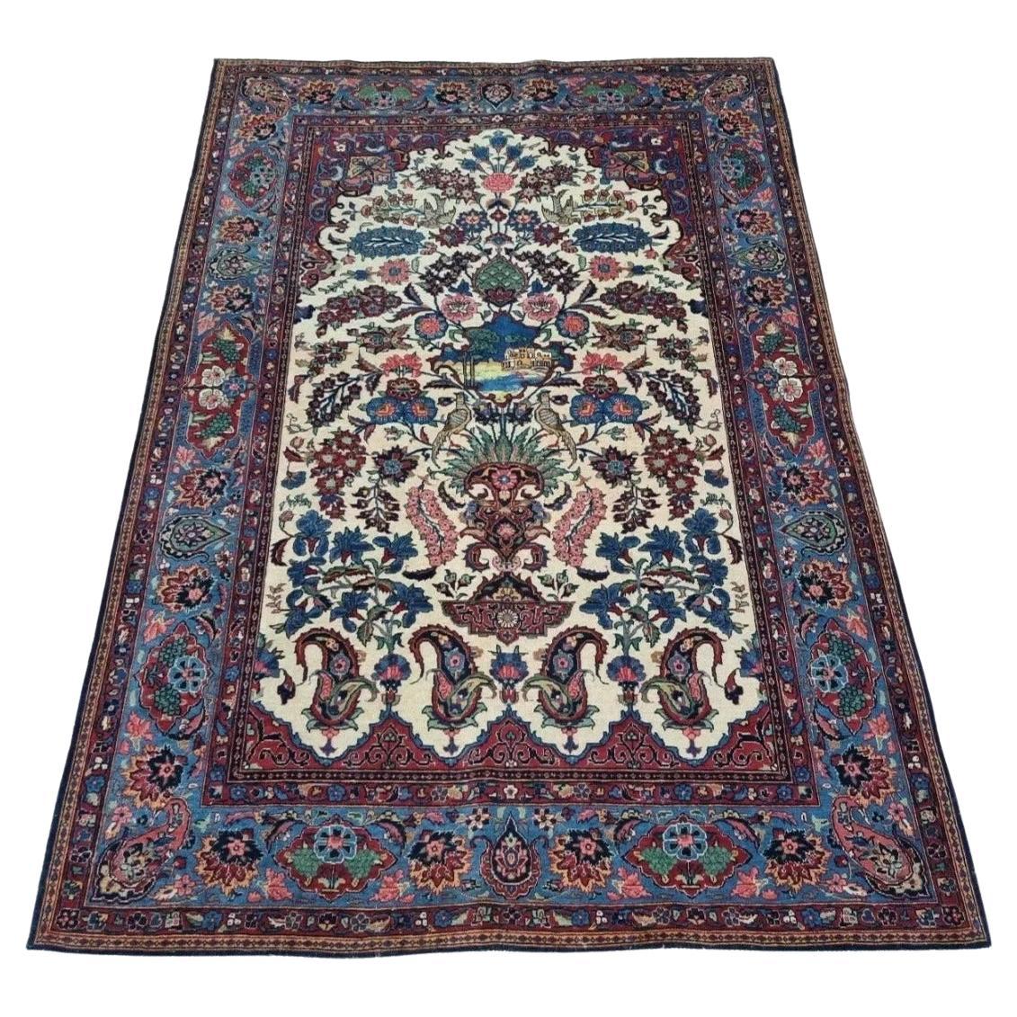 Full view of an antique Persian Kashan (Keschan) rug from the 1920s, featuring a soft beige field with an intricate floral medallion and elaborate corner spandrels, hand-knotted in wool on a cotton foundation.

