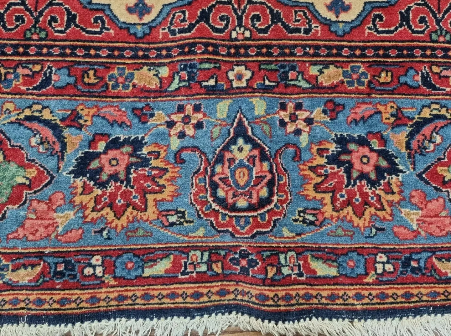 Medium-sized vintage Persian Kashan rug in excellent condition for its age (over 100 years old), with a soft beige palette, intricate floral medallions, and minimal wear consistent with antique status.

