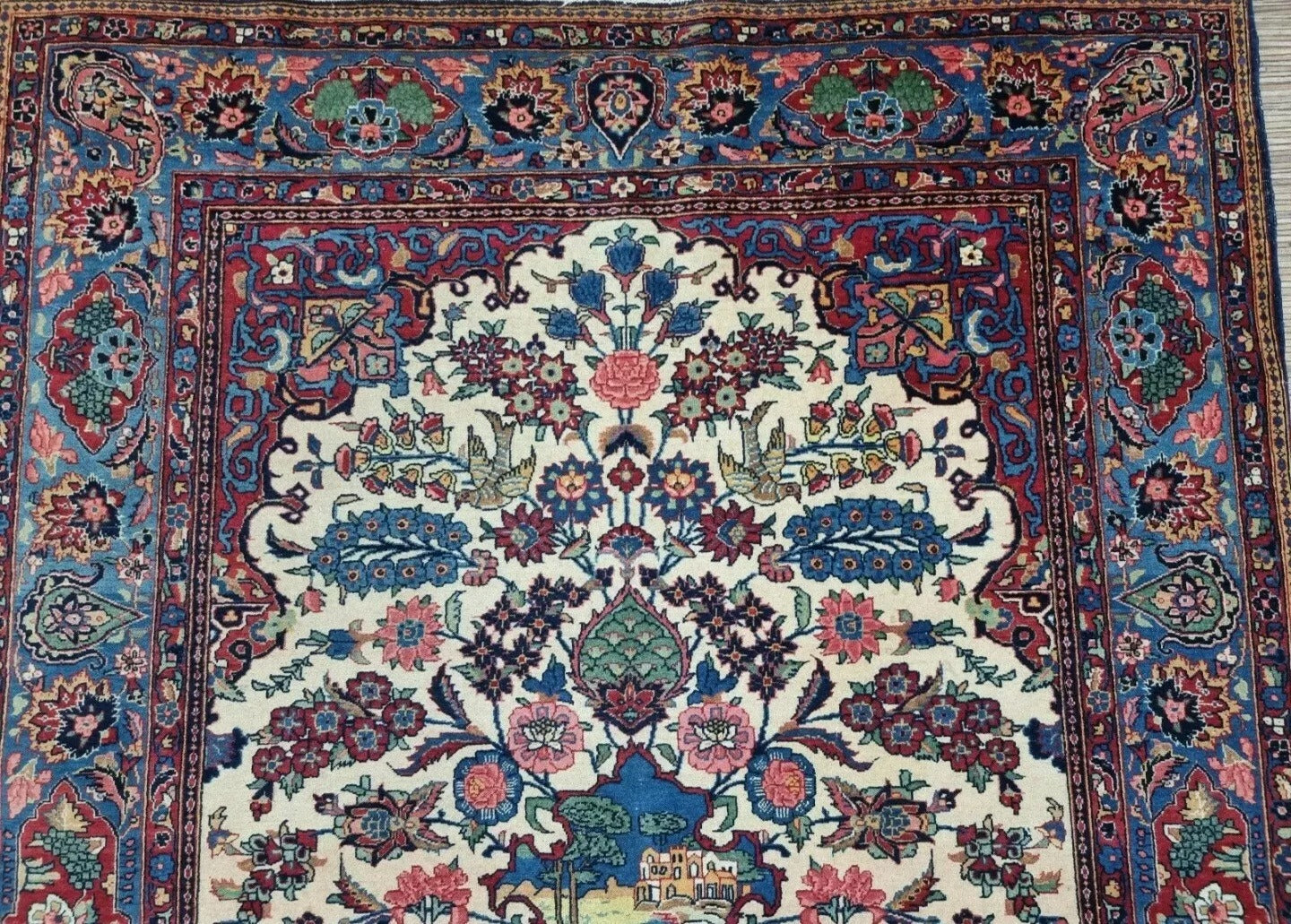 Collector-quality antique Persian Kashan rug circa 1920s with a soft beige field, ornate floral medallion, richly detailed corner spandrels, and a harmoniously patterned border system.

