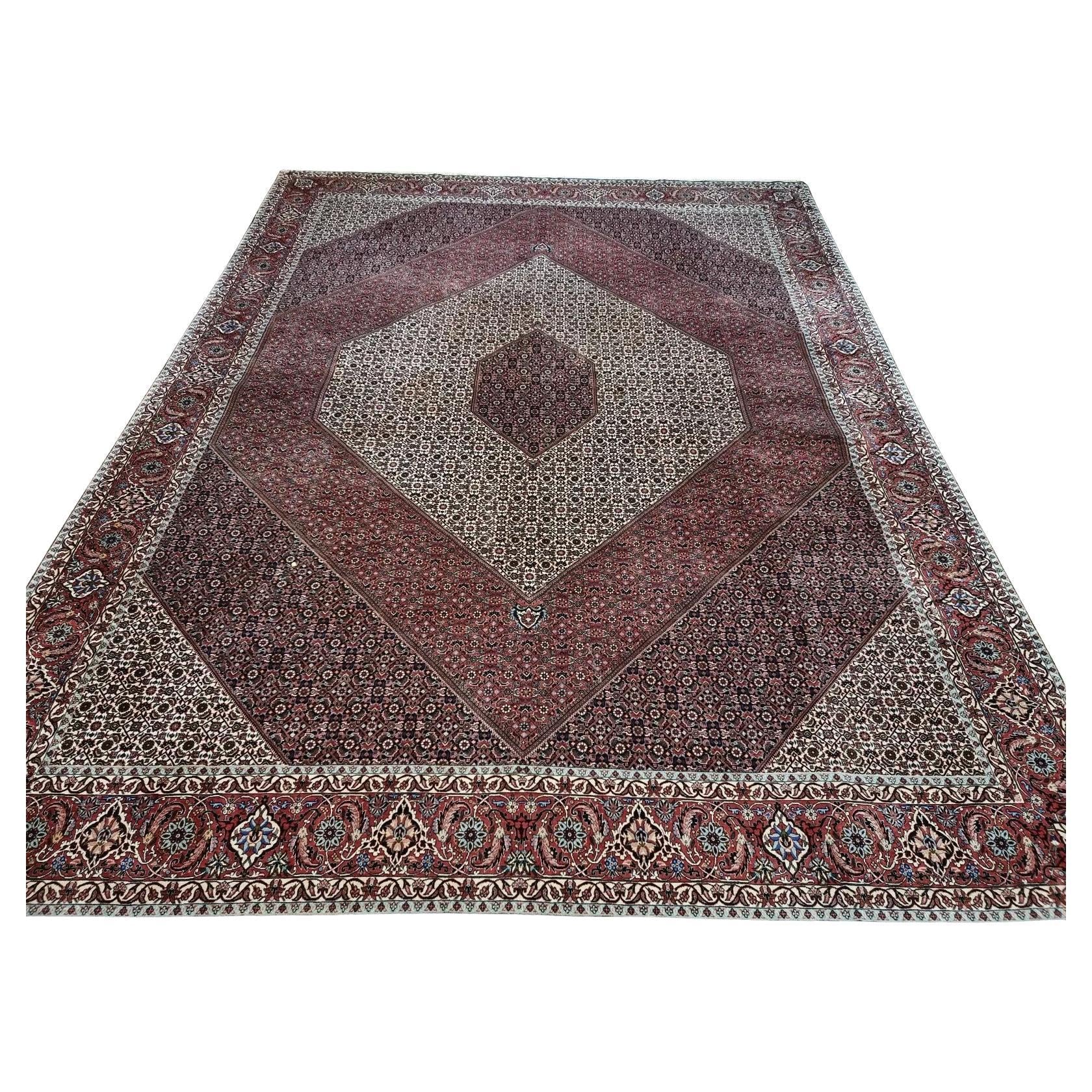 Full view of a handmade vintage Persian Bidjar rug from the 1970s, featuring a rich red field with an elaborate central medallion and intricate floral patterns, hand-knotted in wool on a cotton foundation – known as "the iron rug of Persia" for its exceptional durability.

