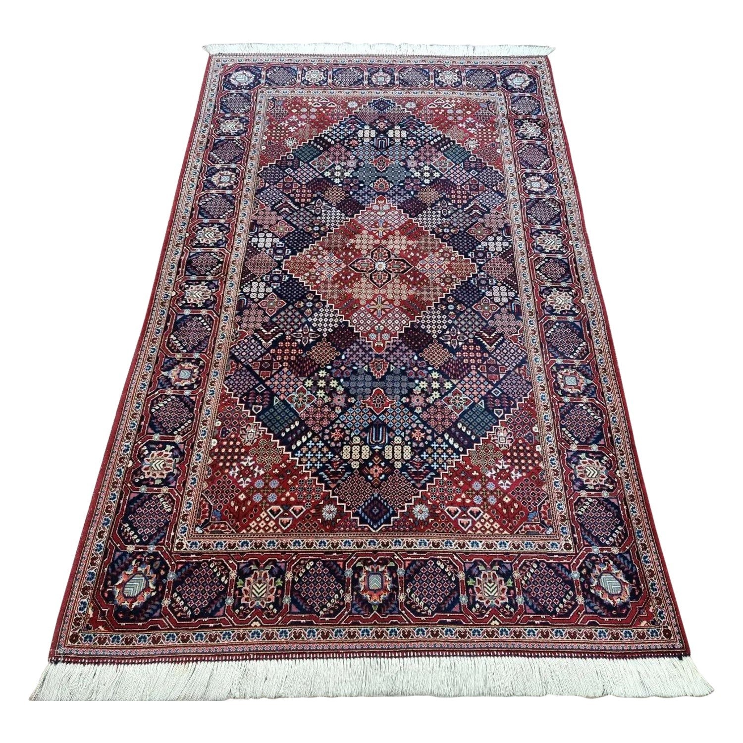 Full view of a handmade vintage Persian Kashan rug from the 1950s, featuring a vibrant blue field with an elegant geometric pattern and classic Kashan motifs, hand-knotted in pure wool on a cotton foundation.

