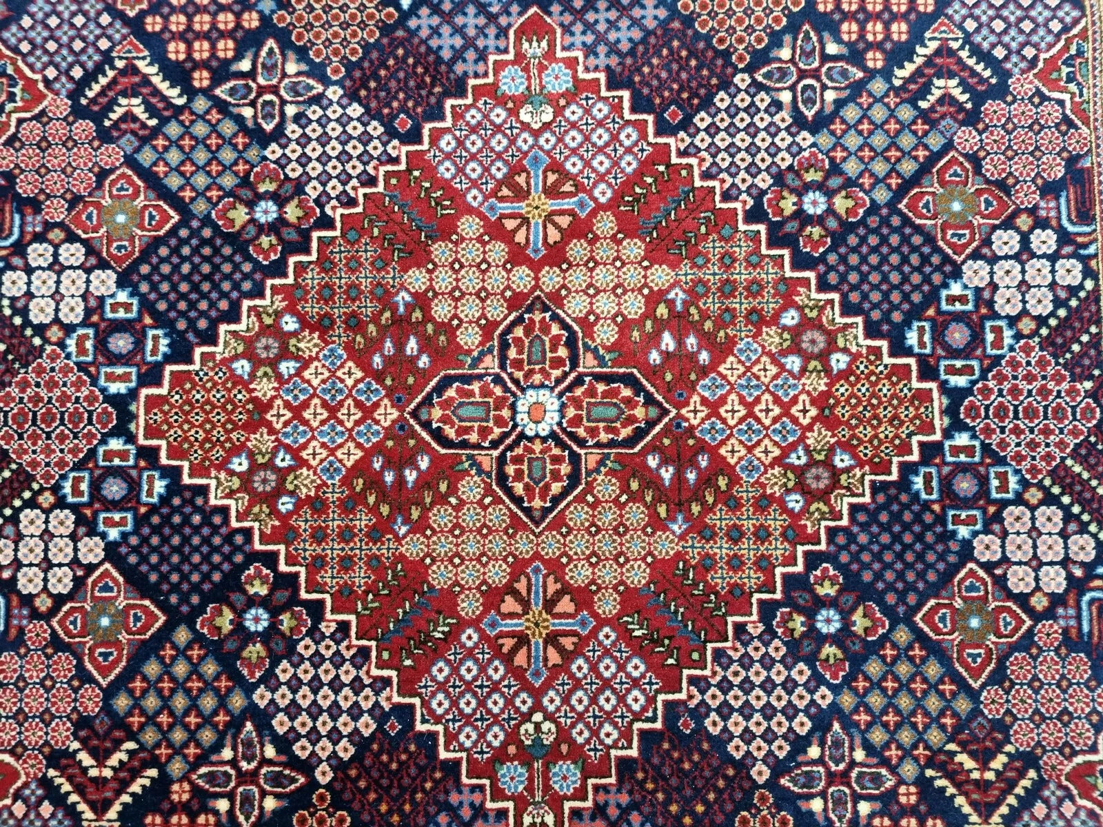Close-up of the high-quality wool weave on a 1950s Persian Kashan rug, showing the hand-knotted pure wool pile on a durable cotton foundation with meticulous attention to detail.

