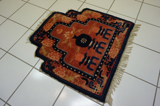 Intricate Floral and Geometric Motifs: Close-up of the central medallion showcasing the intricate floral and geometric patterns of this antique Chinese Ningxia rug.