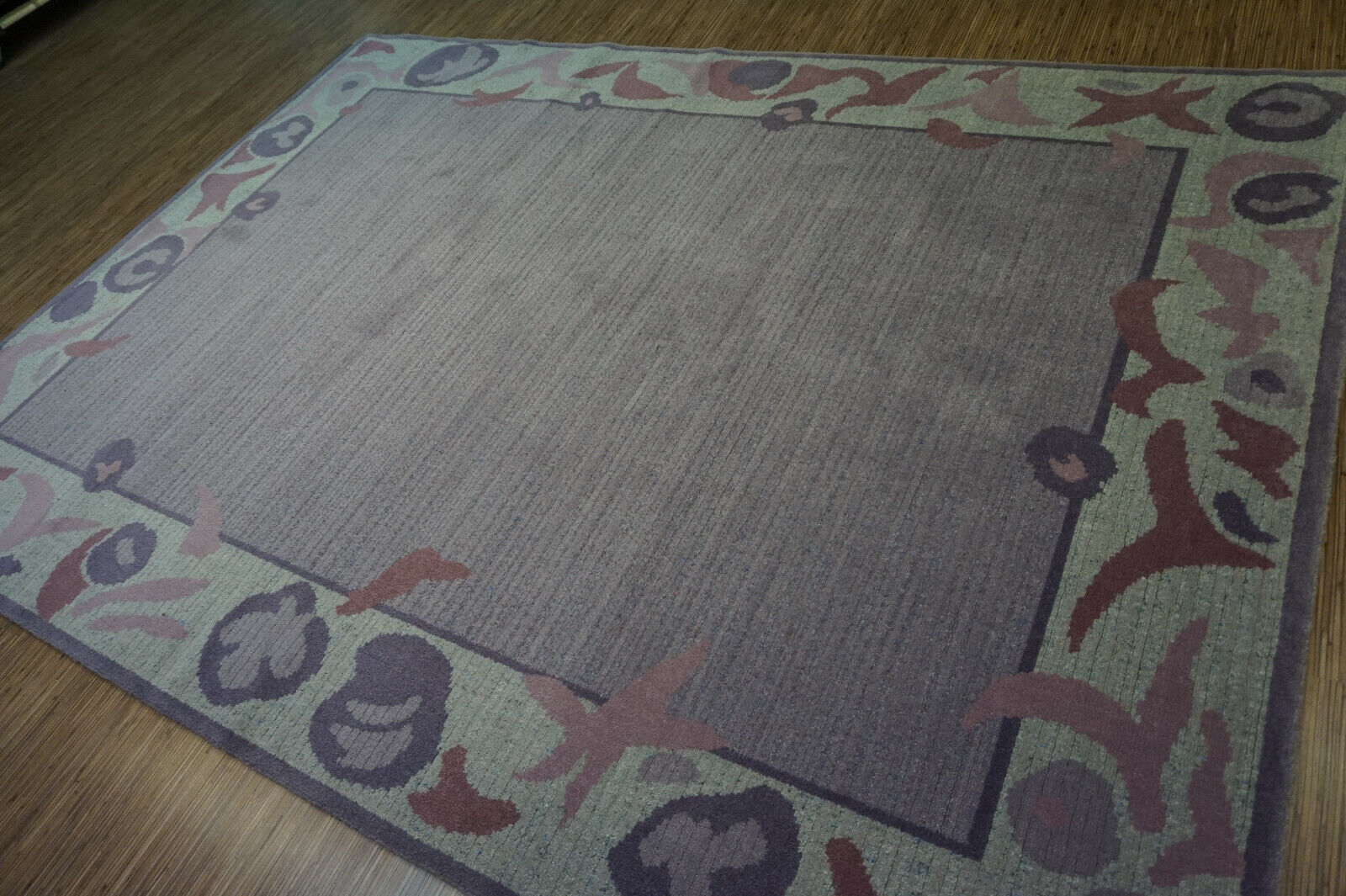 Vibrant purple hues in the main section of the Vintage B&C Rug