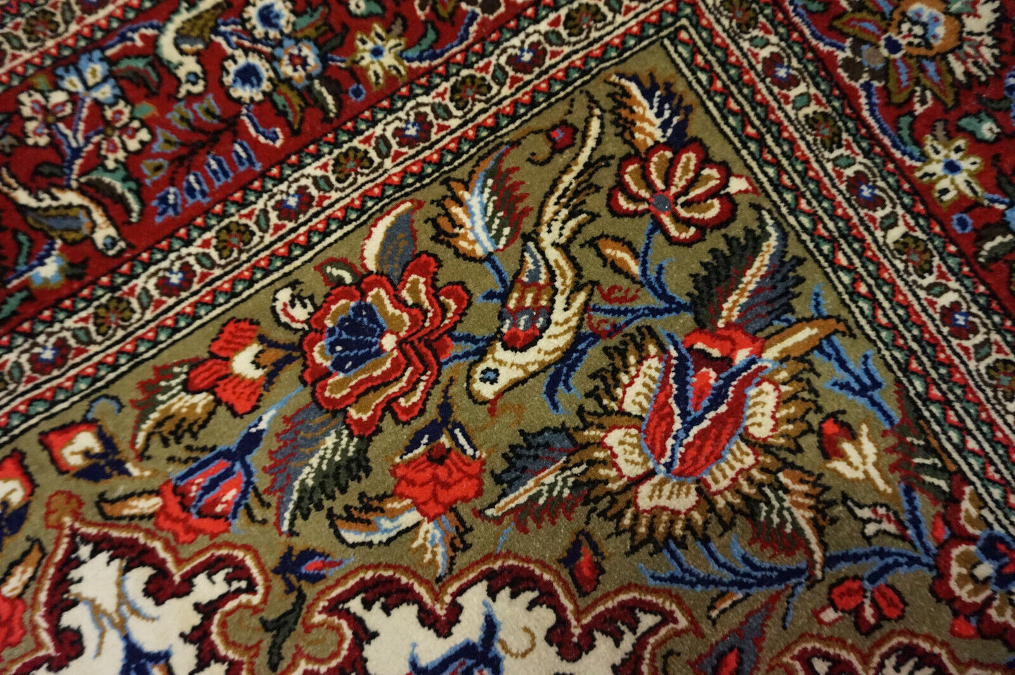 Close-up of joyous bird patterns woven into the Vintage Prayer Rug