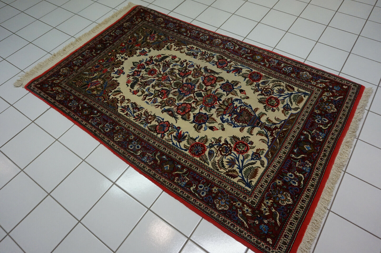 Tree of life motif in vibrant colors on the Vintage Qum Rug