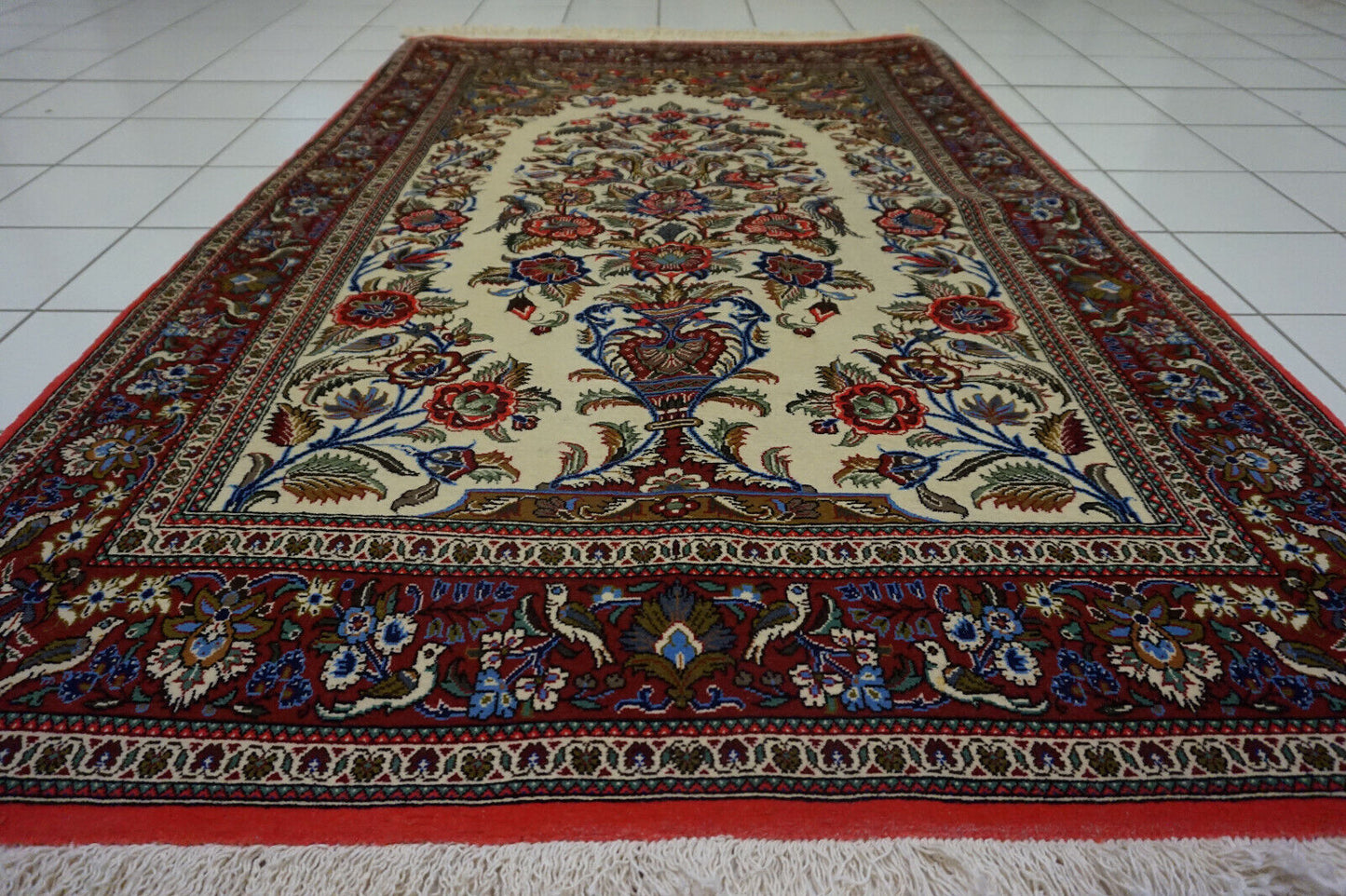 Ivory background showcasing floral patterns on the Prayer Rug