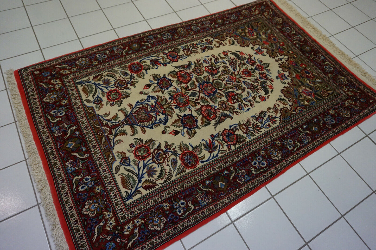 Detailed view of red floral patterns on the Persian Style Rug