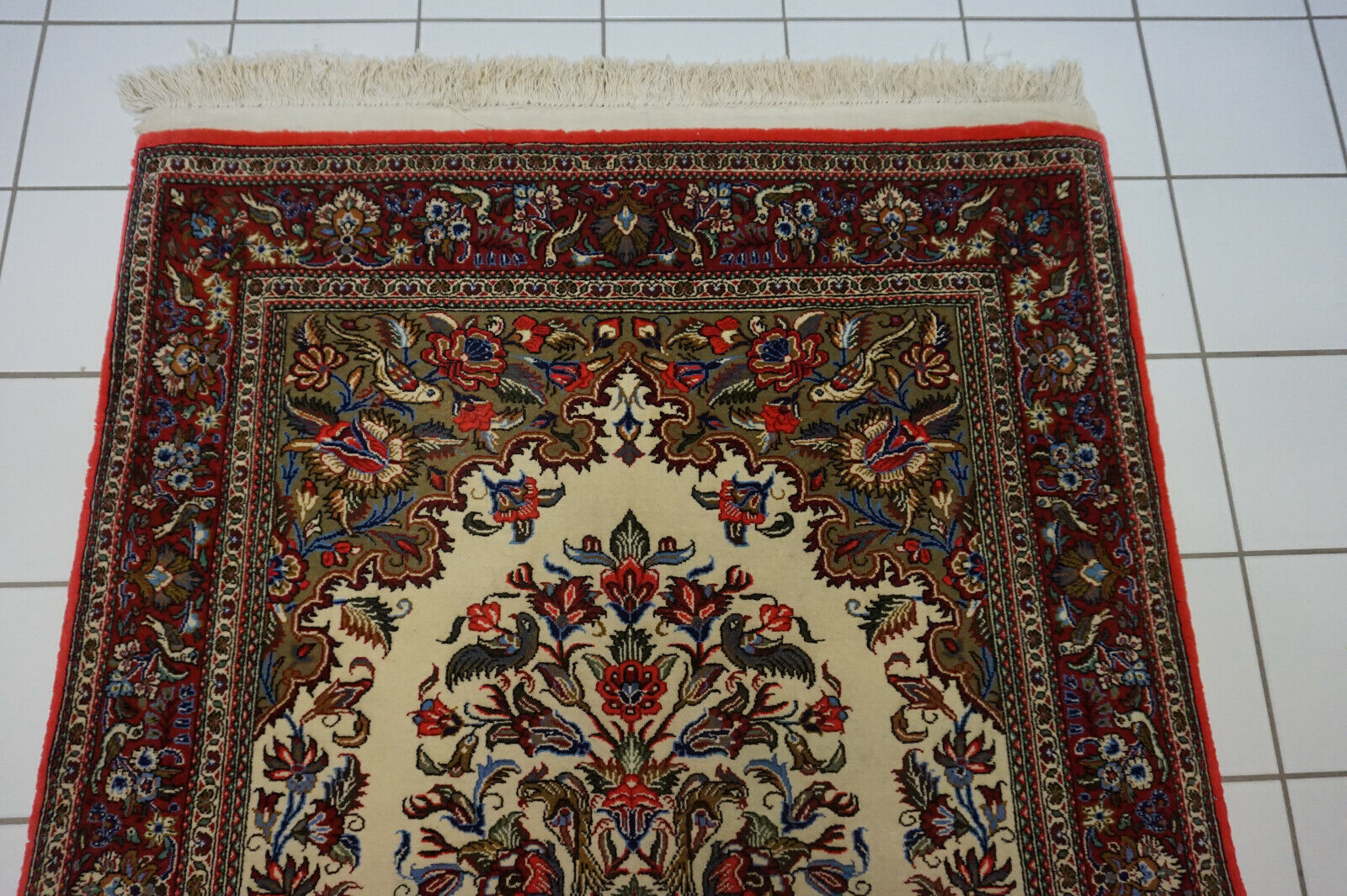 Blue floral motifs adding vibrancy to the Handmade Vintage Rug