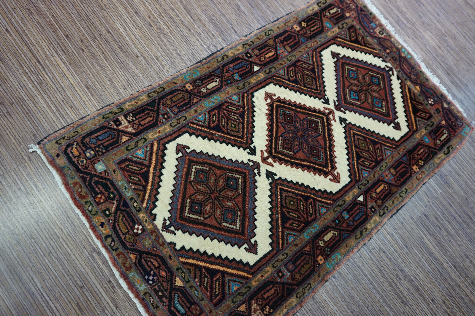 Close-up detail of intricate diamond-shaped patterns on the Hamadan Rug