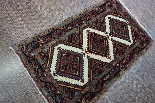 Close-up detail of intricate diamond-shaped patterns on the Hamadan Rug