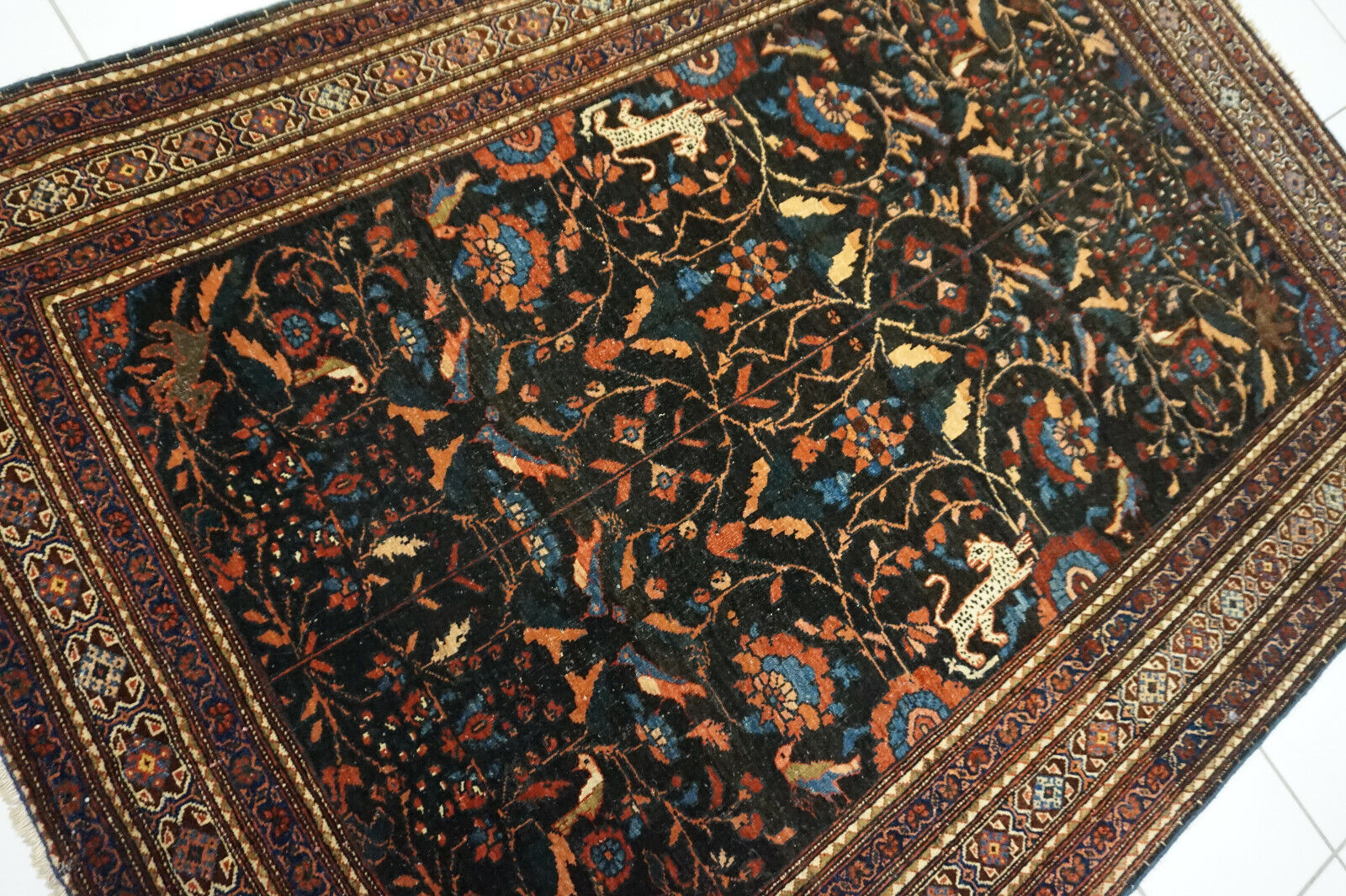 Side angle shot of the Handmade Antique Persian Tehran Rug showcasing size and scale