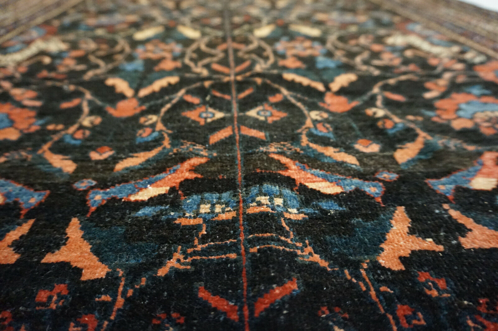 Detailed shot of the rich color palette on the Handmade Antique Persian Tehran Rug