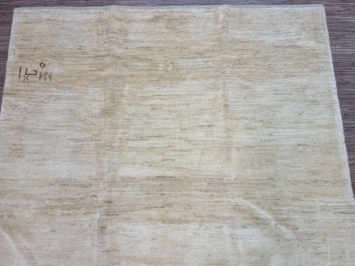 Close-up of the subtle variations in tone and texture of the Persian Gabbeh rug