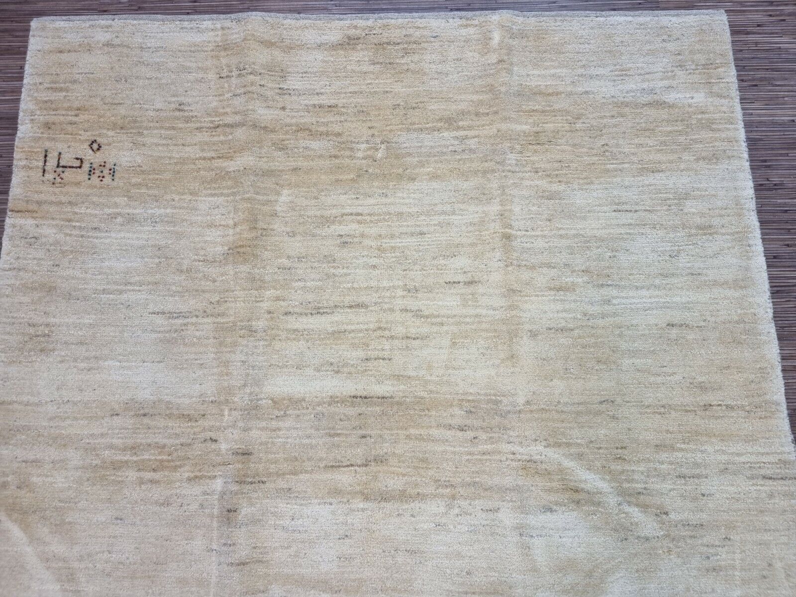 Close-up of the subtle variations in tone and texture of the Persian Gabbeh rug