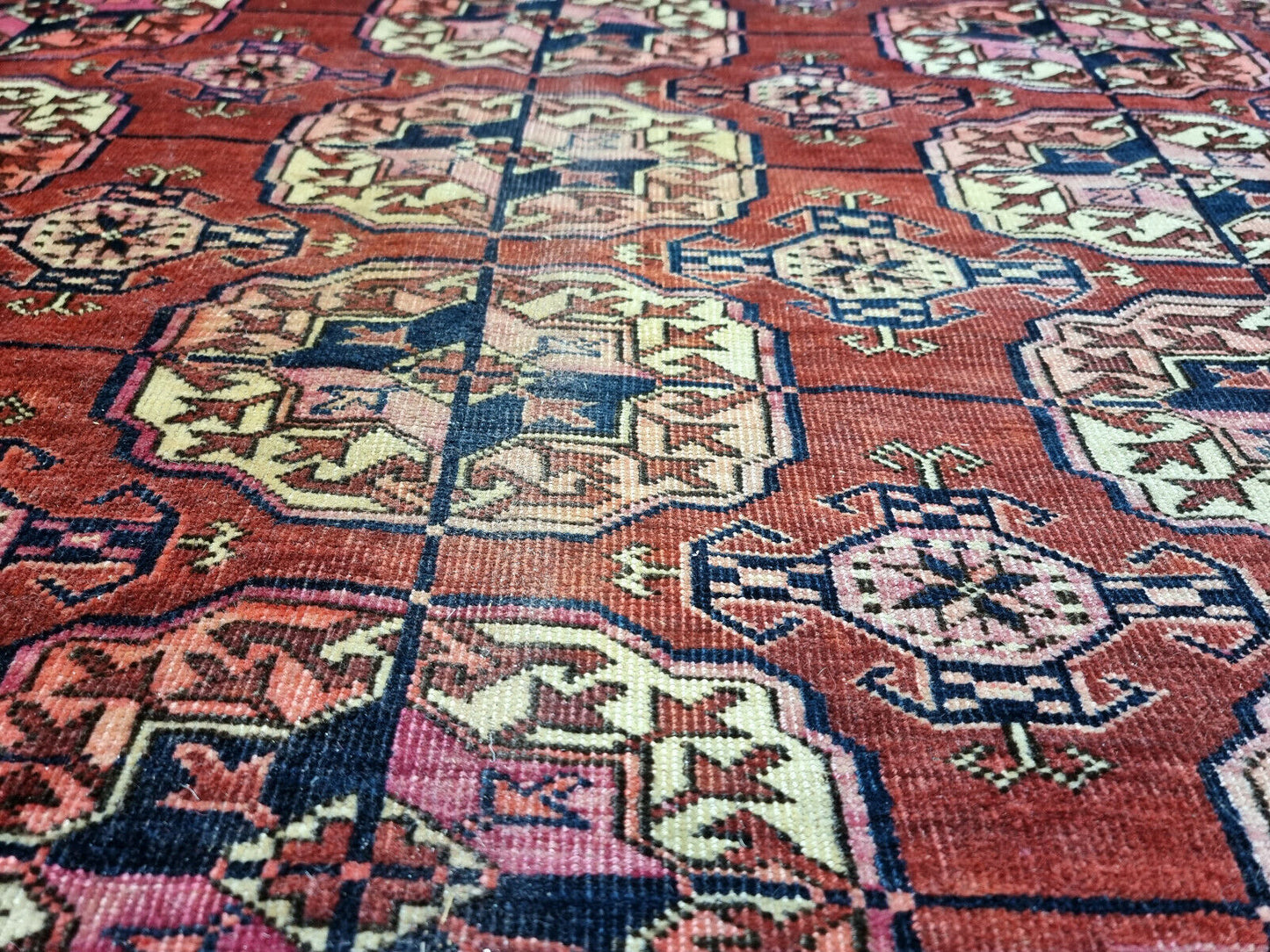 Close-up of signs of age and discoloration on Handmade Antique Turkmen Tekke Rug - Detailed view showcasing the antique nature of the rug with visible signs of age.