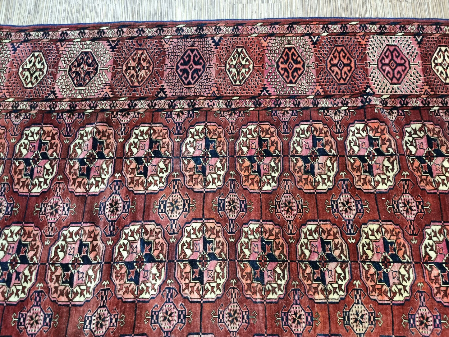 Close-up of rug's unique character on Handmade Antique Turkmen Tekke Rug - Detailed view showcasing the unique character and charm of the antique rug.