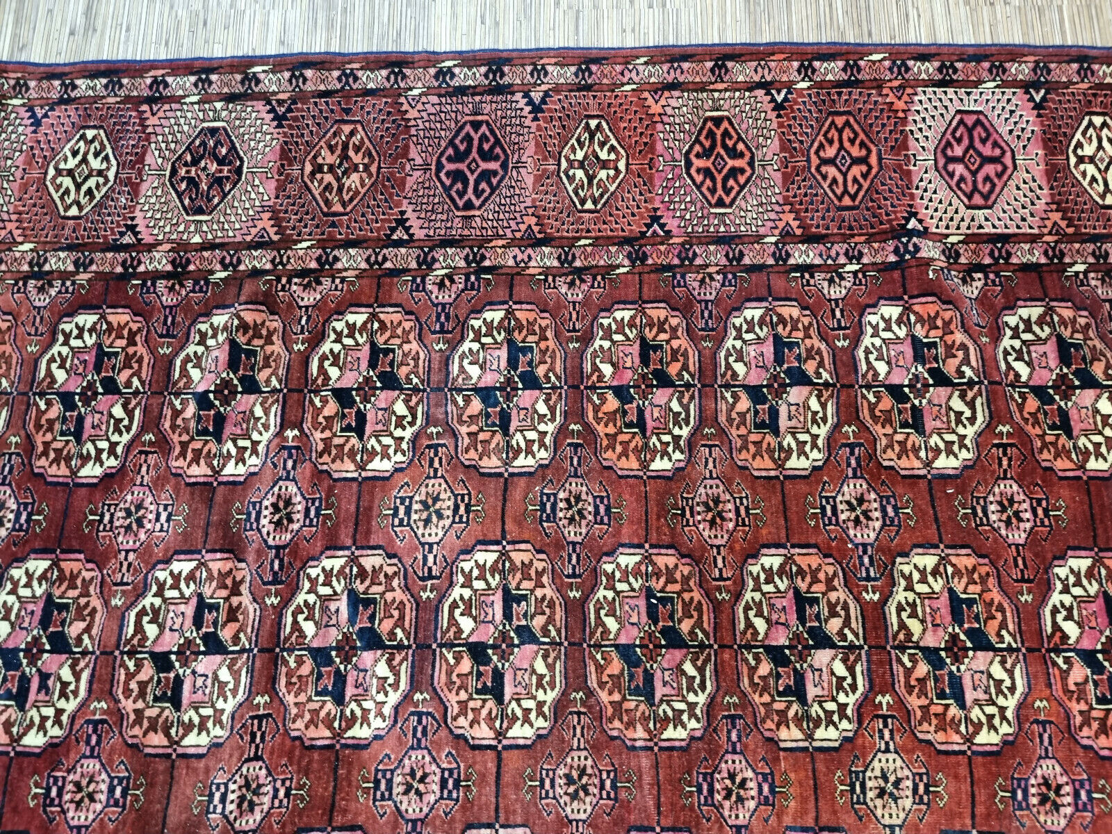 Close-up of rug's unique character on Handmade Antique Turkmen Tekke Rug - Detailed view showcasing the unique character and charm of the antique rug.