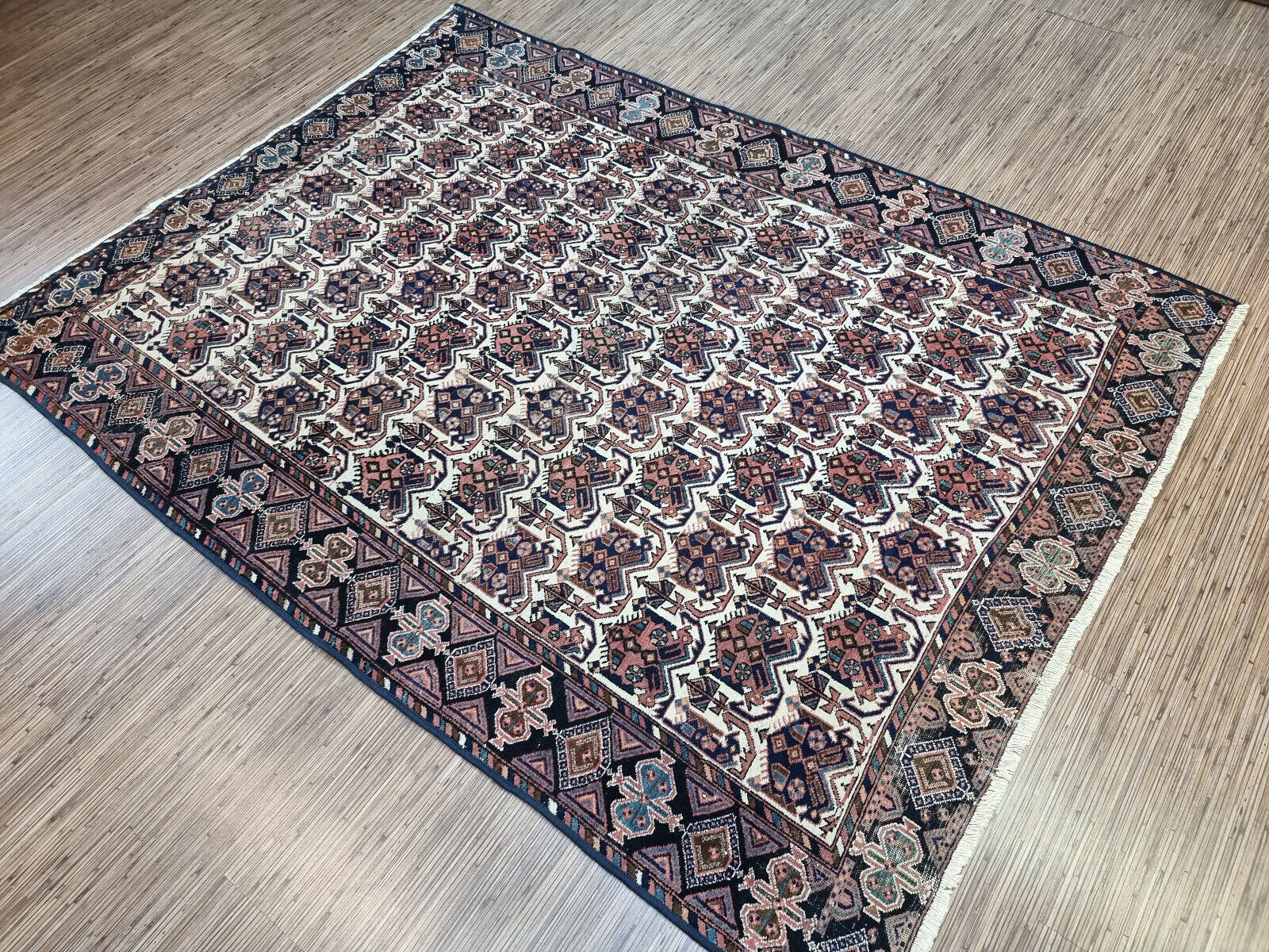 Deep blue Afshar rug (1920s) boasts rich colors and intricate details for a luxurious feel.