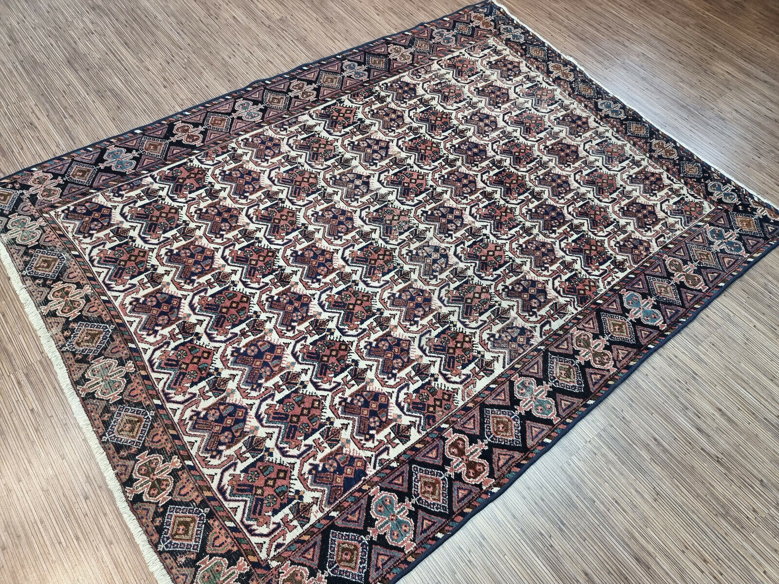 Symmetrical beauty: 1920s Afshar rug with deep blue, red, cream, and beige accents.