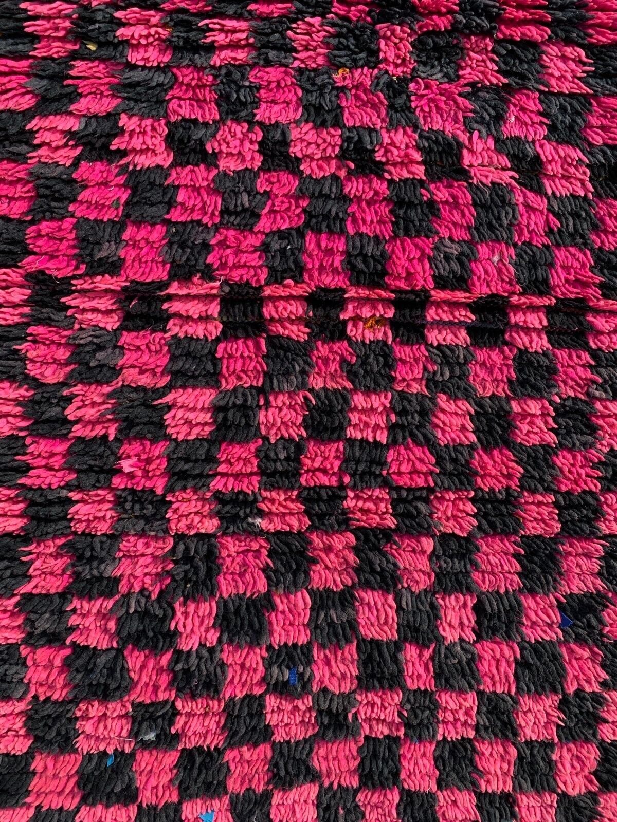 Close-up of the striking contrast between the bold black and fuchsia squares