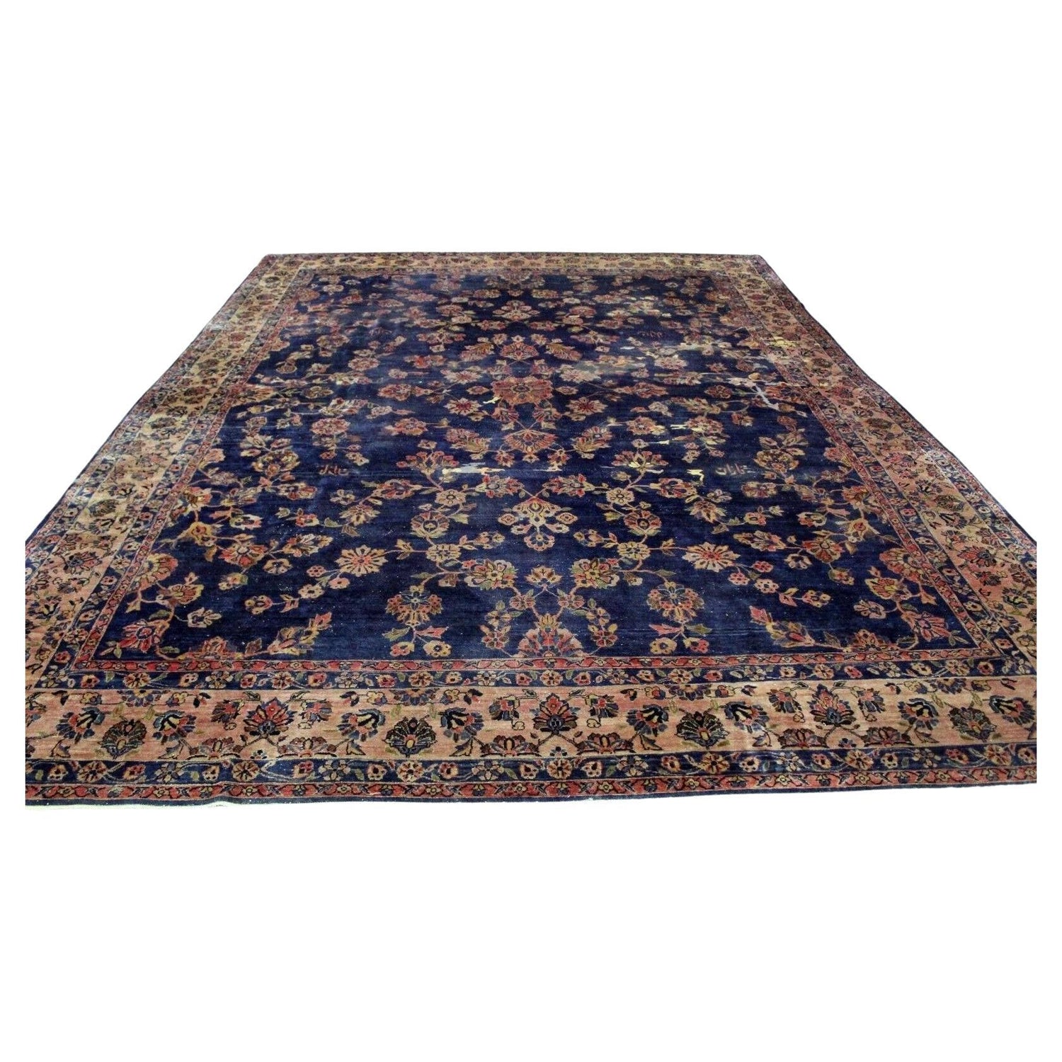 Close-up of intricate floral motifs on a Persian Sarouk rug

