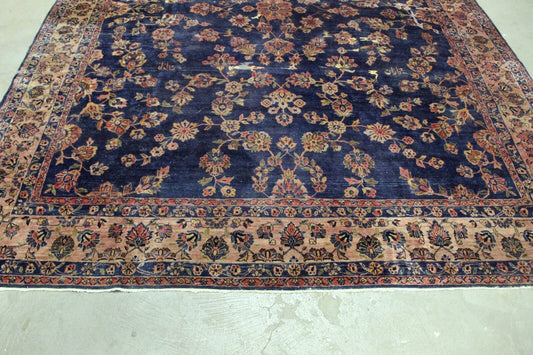 Handmade Persian Sarouk rug featuring deep red and navy blue hues

