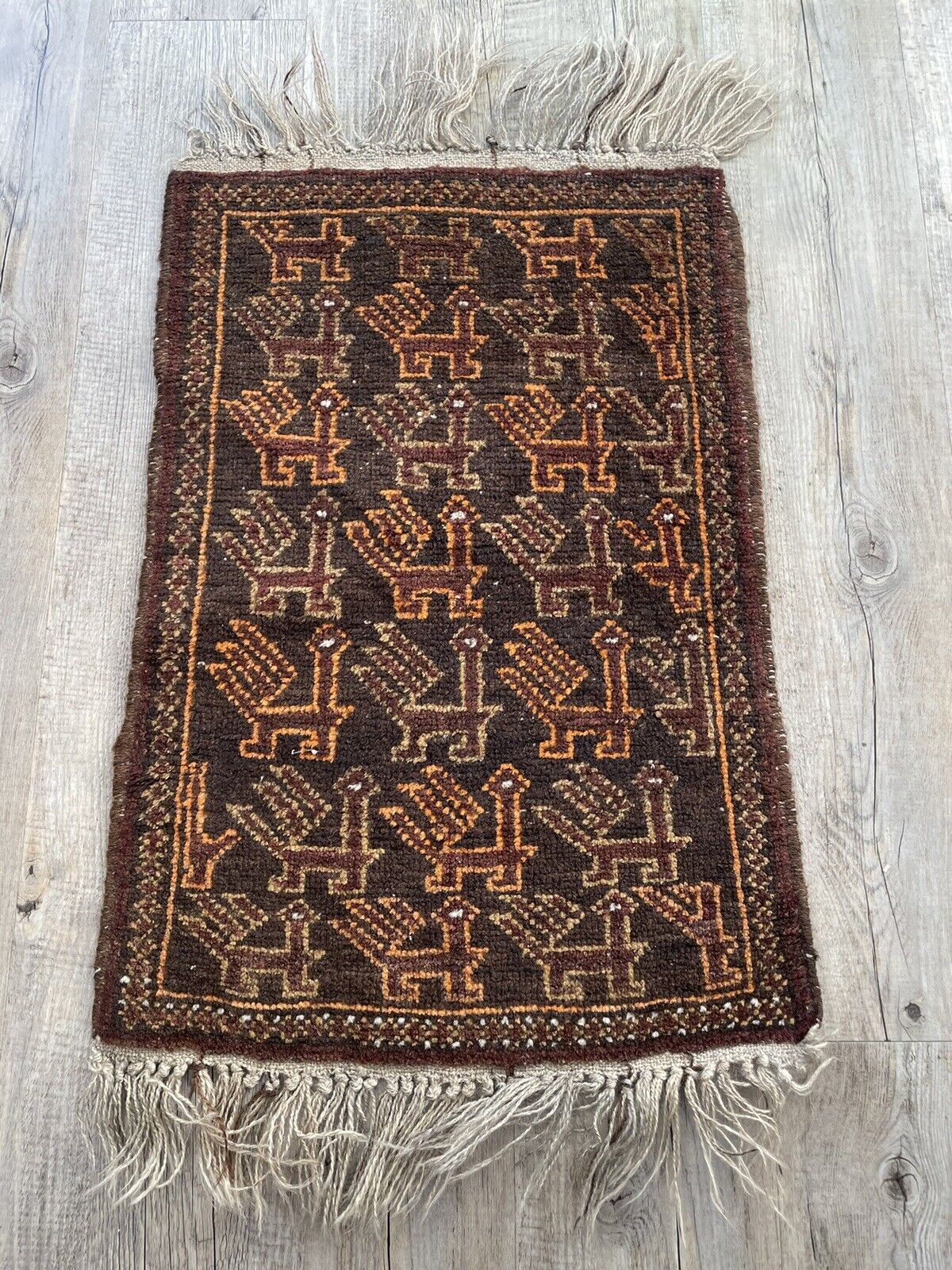 Handmade Vintage Afghan Baluch Collectible Rug - 1940s - Unique repeating animal design showcased in a small-sized rug.