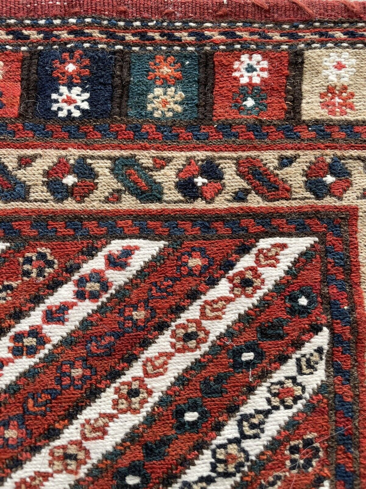 Close-up of vibrant colors on Handmade Vintage Persian Kurdish Salt Bag - Detailed view showcasing the vibrant natural colors of the salt bag's design, including red, black, white, and blue.