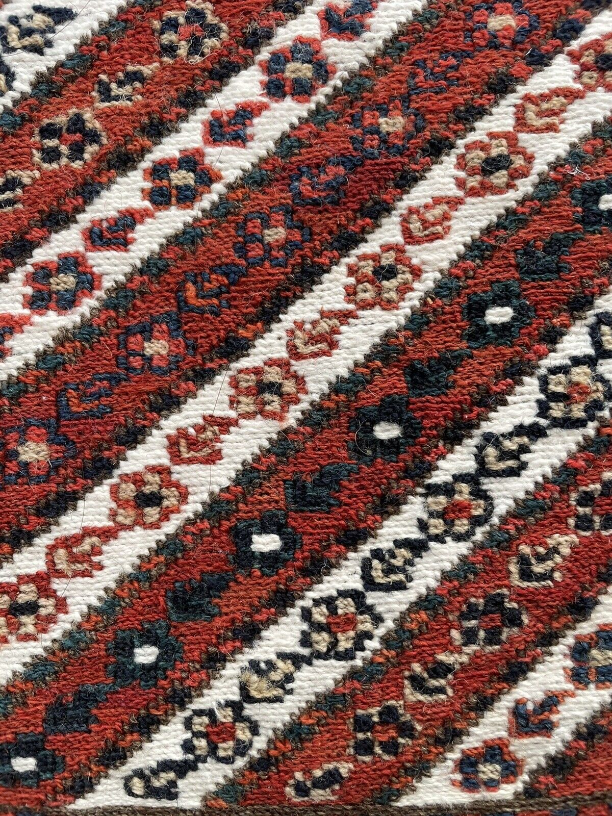 Close-up of geometric motifs on Handmade Vintage Persian Kurdish Salt Bag - Detailed view showcasing the detailed geometric motifs woven into the diagonal stripes of the bag.