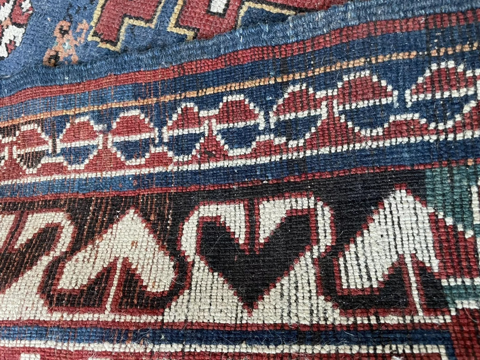 A section of the rug showcasing the density of the symbolic design elements.

