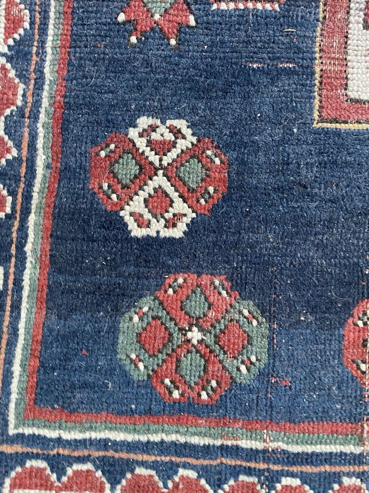Close-up showcasing the weathered texture and patina of the antique wool.

