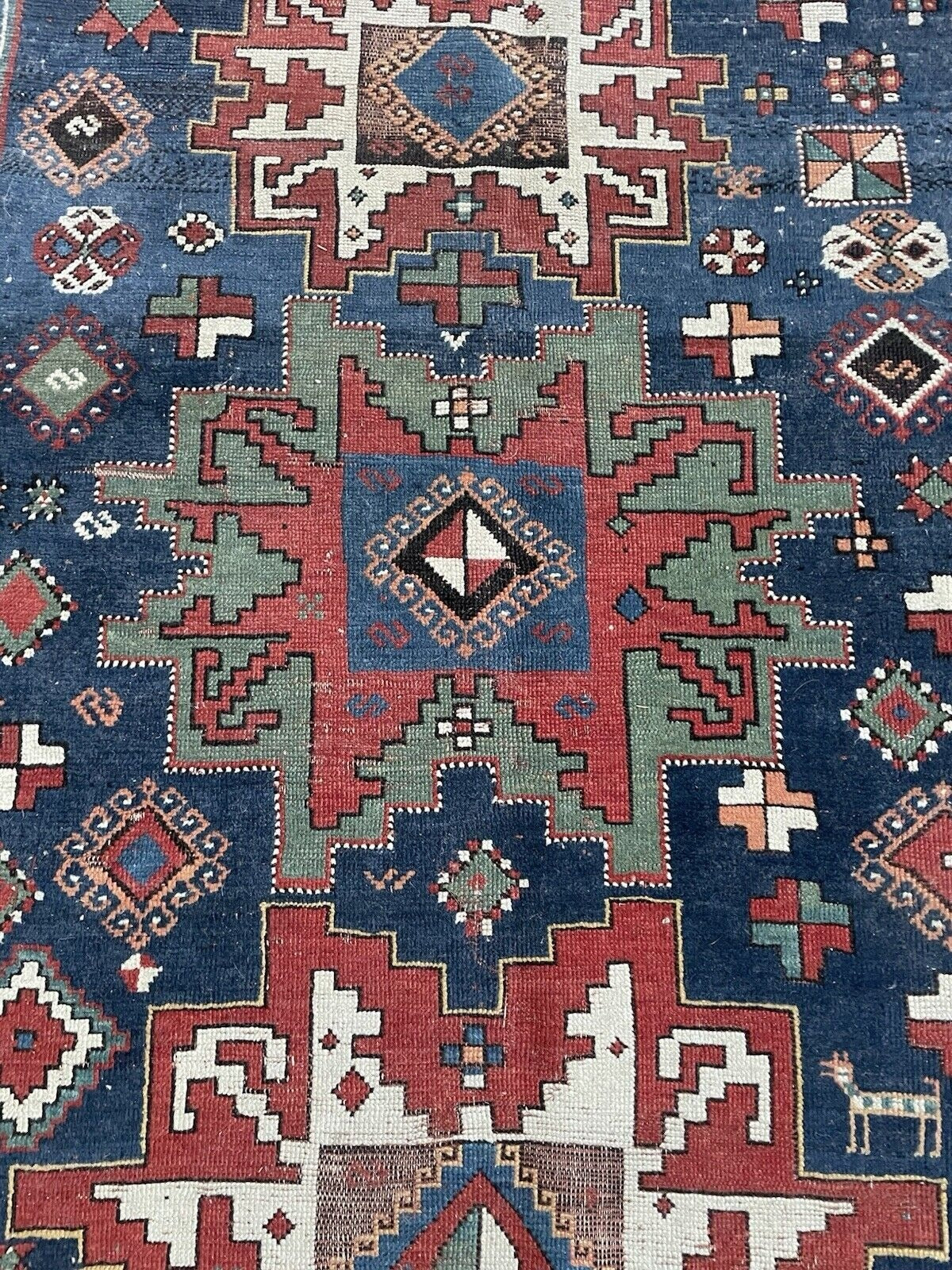 View of the rug's end, highlighting the complete border sequence.

