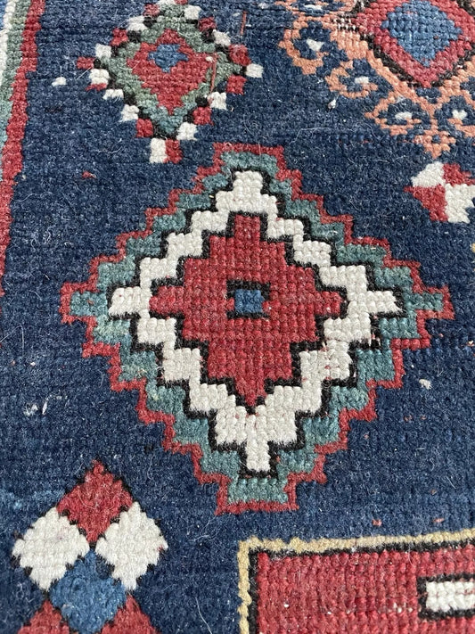 Close-up detail of the powerful central medallion in red, white, and navy.

